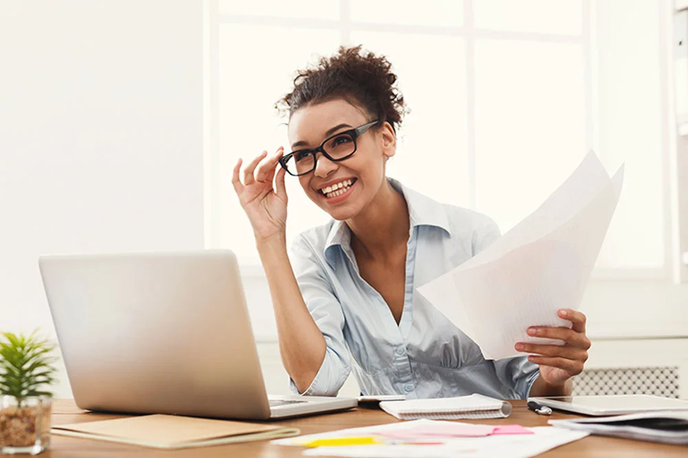 Smiling Woman Sitting at Her Desk