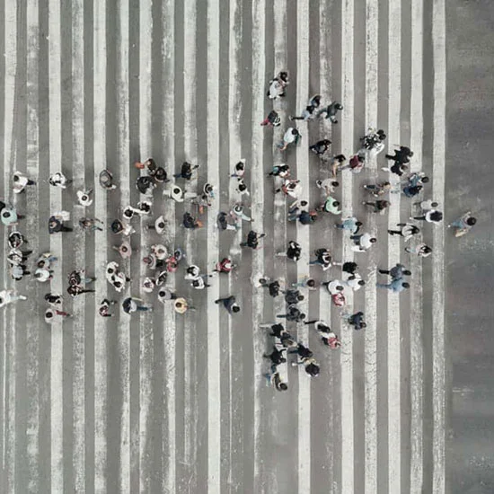 People grouped together to form an arrow pointing right