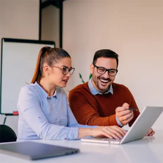 Coworkers reviewing information on a laptop