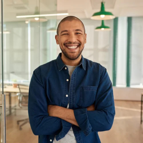 Man with arms crossed smiling and posing