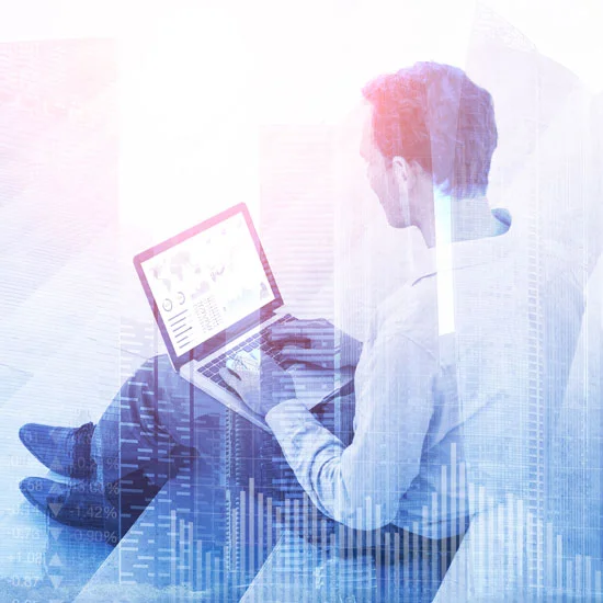 Man sitting on steps, working on his laptop with a 3d digital graphic overlaid