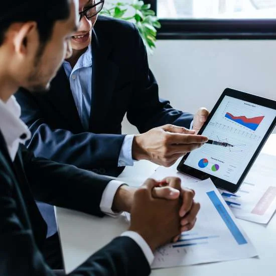 2 people reviewing statistical data in a meeting