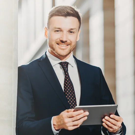 Man standing with tablet looking at camera