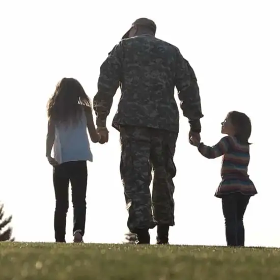 Patra Proud Servicemember Holding Children's Hands