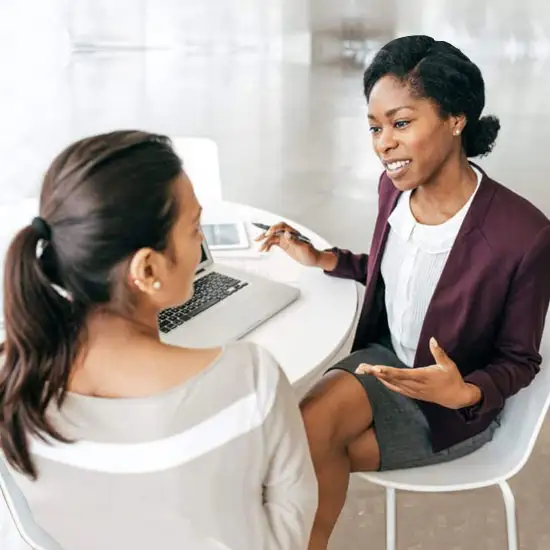 Two women discussing business