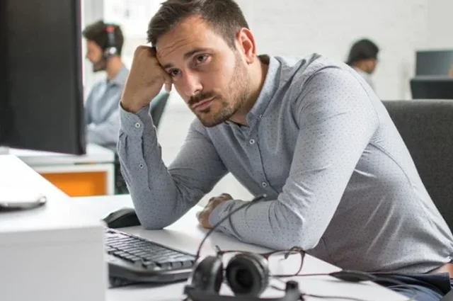 employee looking confused miserable or depressed at work