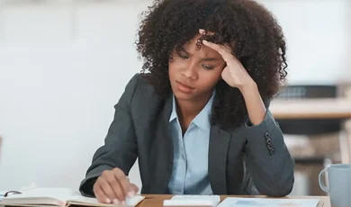 Business woman at work stressing over her work