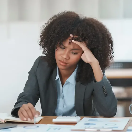 Business woman at work stressing over her work