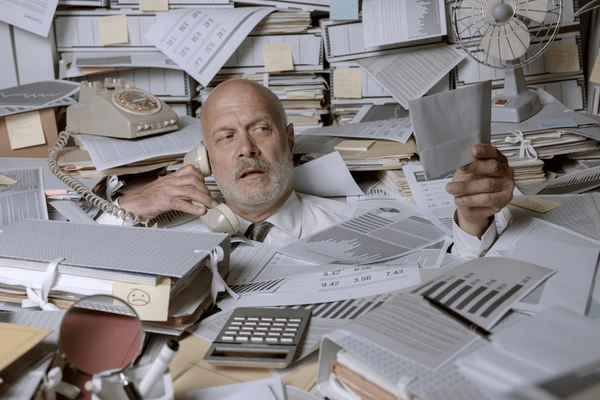 stressed businessman overwhelmed by work stressed businessman overwhelmed by work