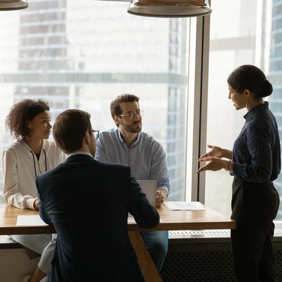 Confident female team leader providing training or guidance to staff