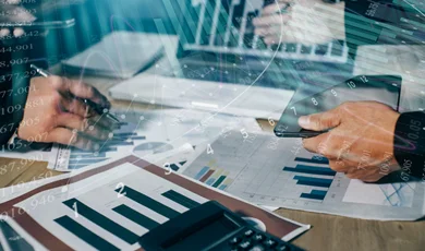 colleagues working on digital laptop reviewing reports and analytics