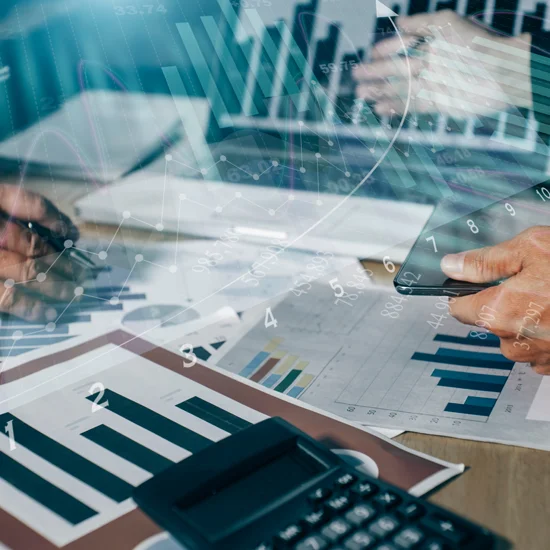 colleagues working on digital laptop reviewing reports and analytics