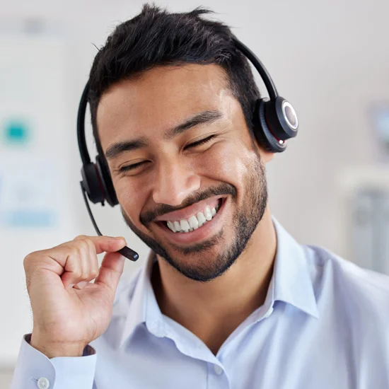 Call center agent, smiling, while talking on a headset
