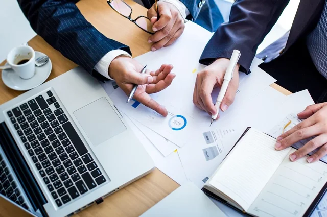 business team reviewing records and data