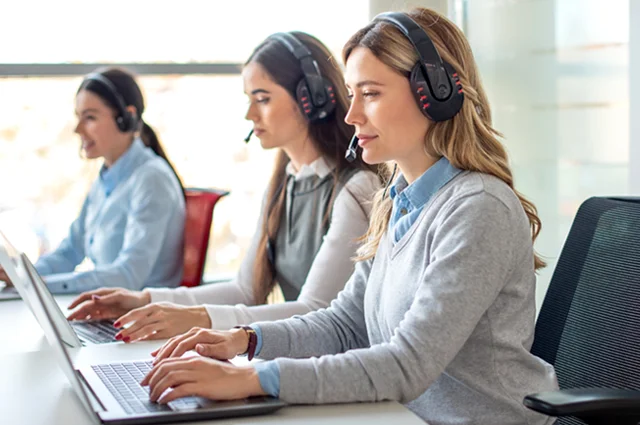 business woman with headset working on laptop