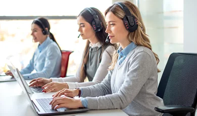 business woman with headset working on laptop