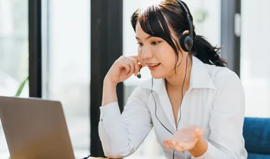 young friendly operator woman agent with headsets working in a call centre