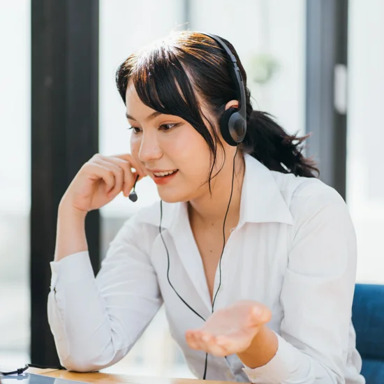 young friendly operator woman agent with headsets working in a call centre