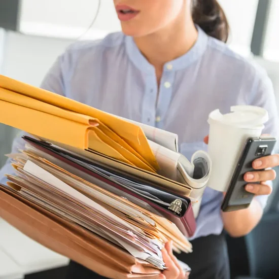 inefficient business woman holding stack