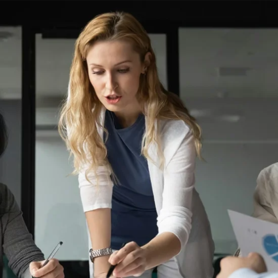 Confident young businesswoman lead team meeting with diverse colleagues