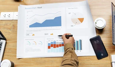 colleagues at a table, working on business strategy and analyzing charts