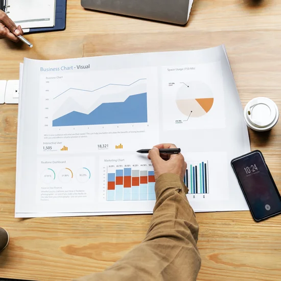 colleagues at a table, working on business strategy and analyzing charts