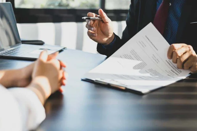 insurance agent reviewing policy documents with client image