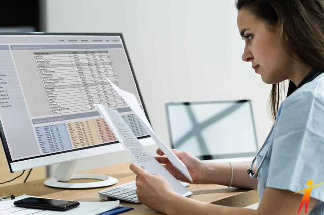 woman reviewing eligibility documents and matching against datbase records