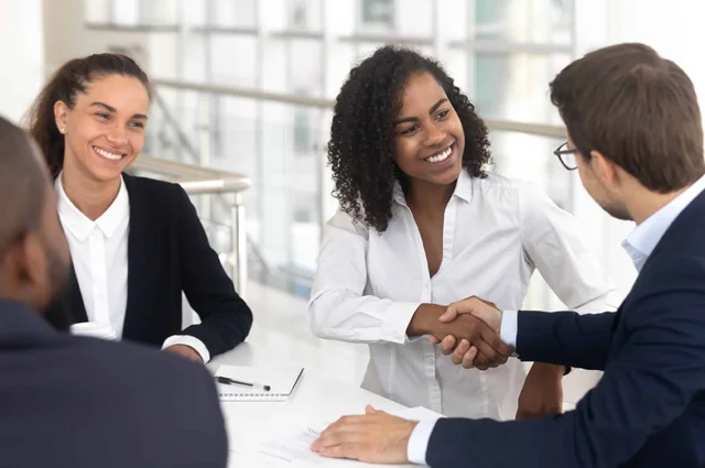 Business handshake — AssuredPartners and Patra partnership