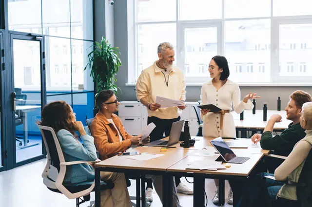 team meeting between colleagues at conference table